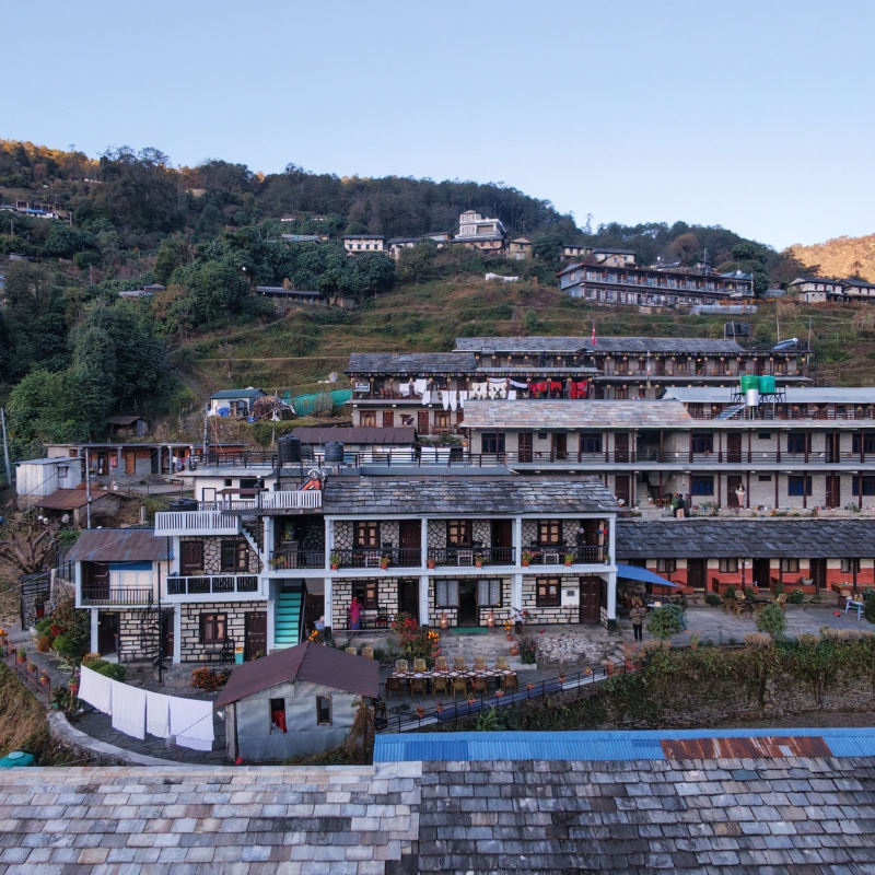 Aerial view of traditional stone-roofed Gurung houses clustered in Ghandruk village during Ghorepani Poon Hill Trekking Nepal.
